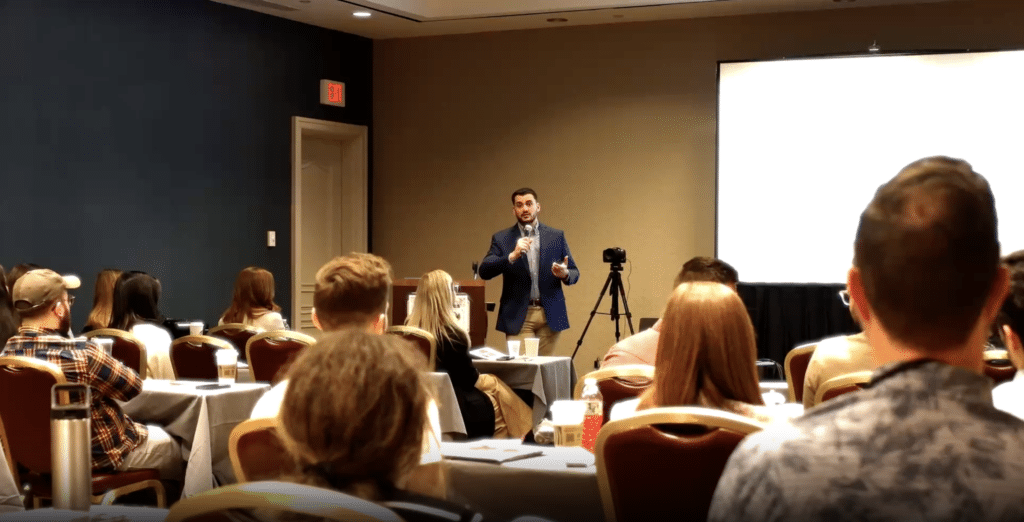 Speaker presenting to an audience at a business workshop